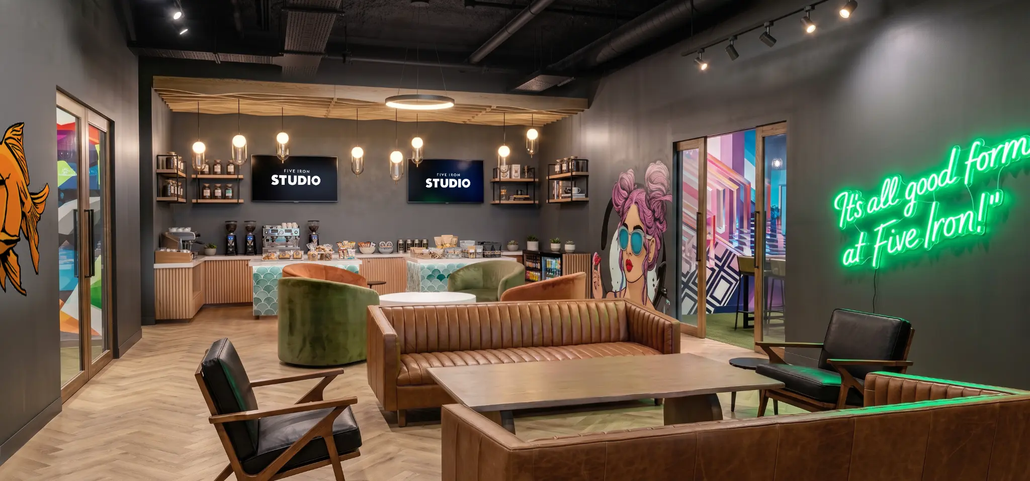 Five Iron Studio lounge with golf bays, café service, and member amenities